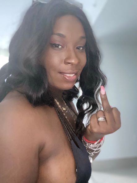 Black Goddess Dominatrix with her Middle finger and Smile